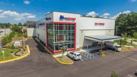 Front view of a self-storage facility with a modern entrance, clear signage, and well-maintained surroundings.