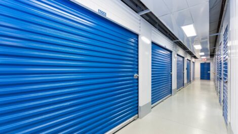 Exterior view of a self-storage facility with modern design and well-marked blue storage units.