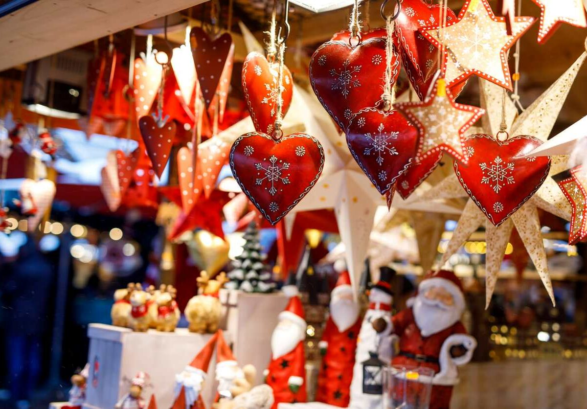 A hanging array of Christmas ornaments at a seasonal market.