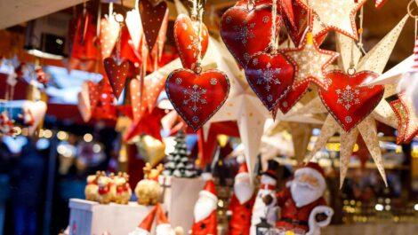 A hanging array of Christmas ornaments at a seasonal market.